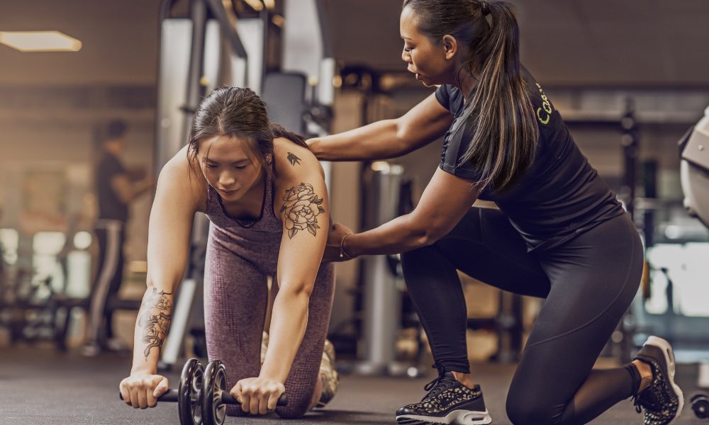 A personal trainer records herself coaching her client, a personal training marketing tip that helps populate social media marketing.