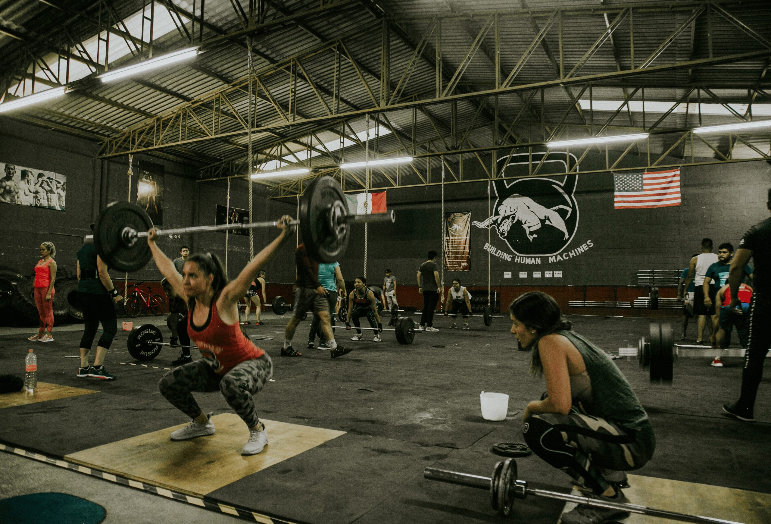 People exercising in a gym, highlighting activities that could require different types of liability insurance for trainers or fitness professionals.