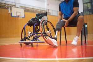 man in a wheelchair on a basketball course.