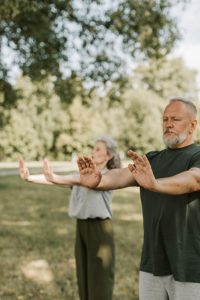 man and woman doing yoga outside