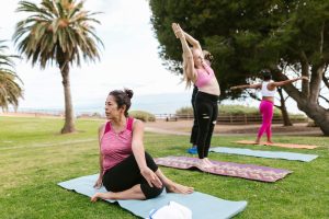 people doing yoga in a park