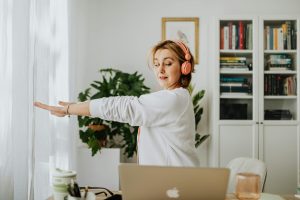 woman performing exercise next to desk