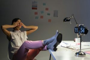 woman at desk stretching