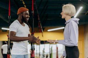 personal trainer and client discussing when it's appropriate to refer to a medical professional