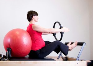 pregnant woman performing pilates