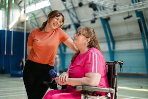 women talking in gymnasium