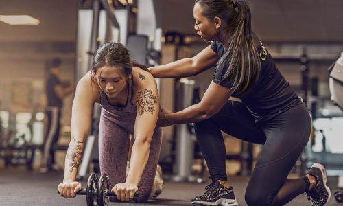 personal-training-marketing-tip A personal trainer records herself coaching her client, a personal training marketing tip that helps populate social media marketing.
