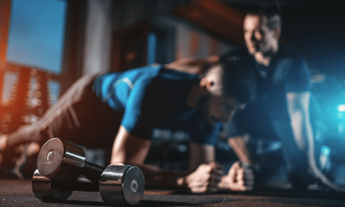 Licensed personal trainer helping client